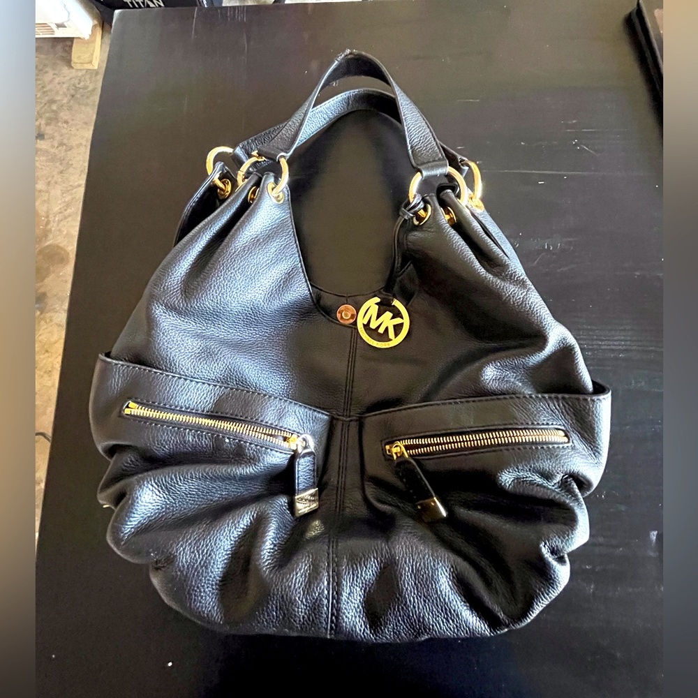 Michael Kors black woman’s handbag